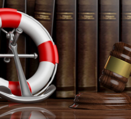 Bildmotiv zu Law of the sea, lawyers office concept. Lifebuoy, navy ship anchor and judge gavel on law books background,