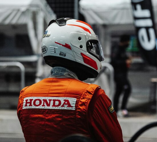Young race car driver in action, focused and determined on the track. Motorsport excitement.